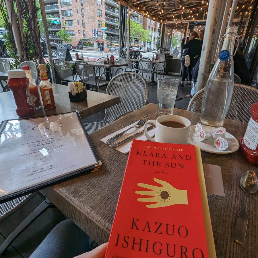 Klara and the Sun book at an outdoor diner
