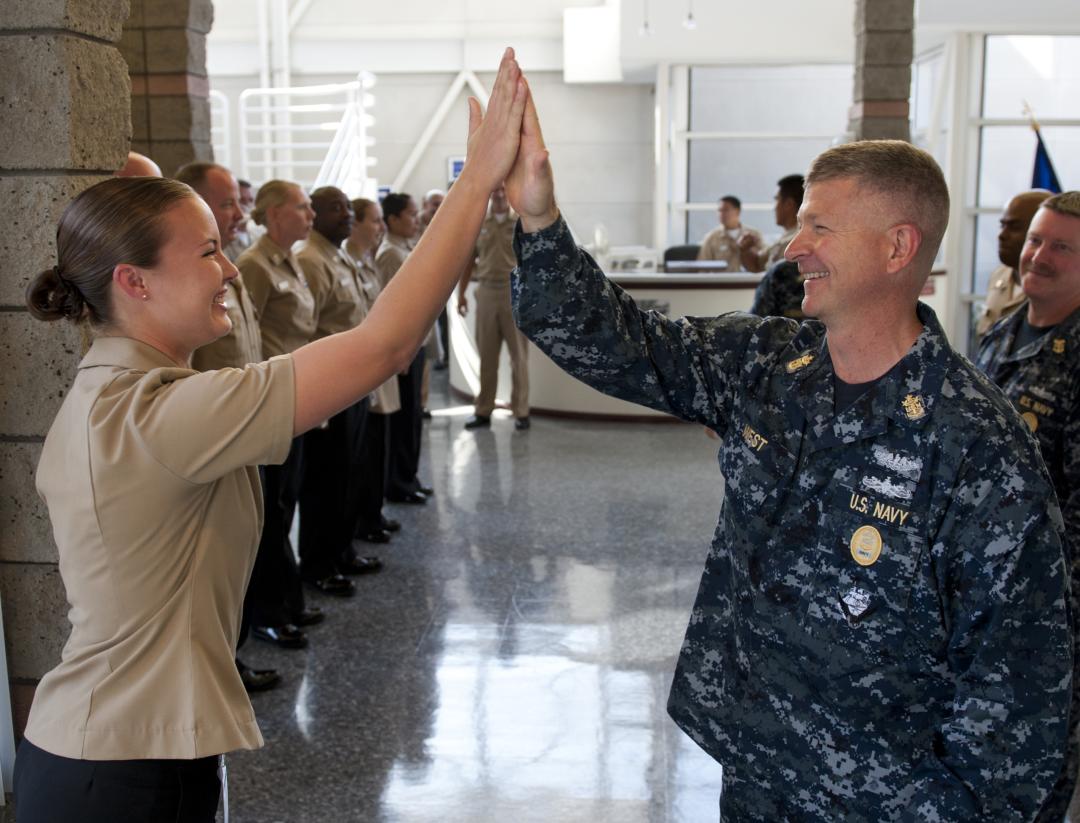 A high five between two US Navy Sailors.