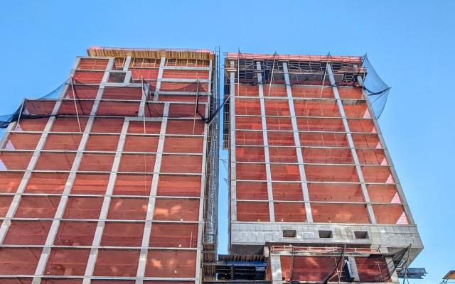 NYC Construction with a new building being build around and overtop an old apartment building