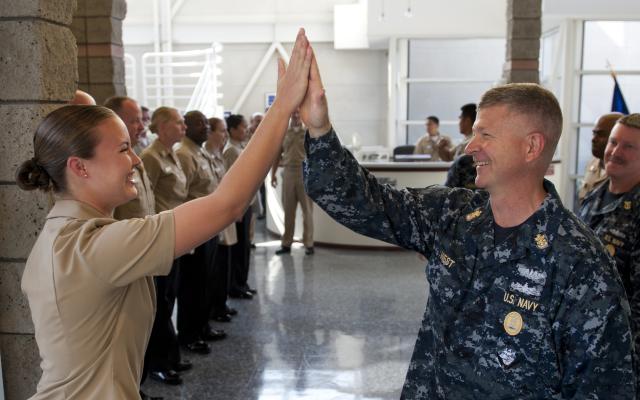 A high five between two US Navy Sailors. 